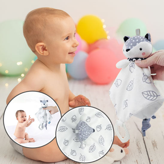 Bébé souriant admire le doudou peluche renard
