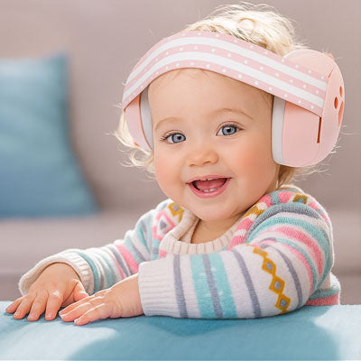 Casque anti-bruit bébé couleur rose fillette souriante 