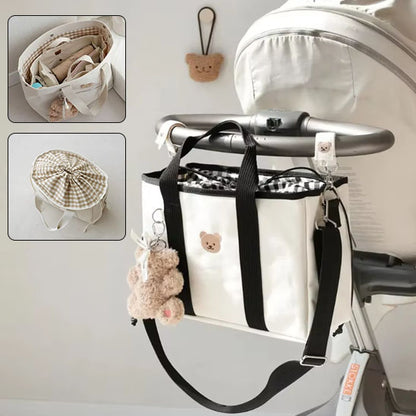 sac à langer maternite pour bébé et maman accroché  à la poussette
